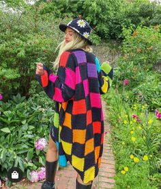 a woman wearing a colorful sweater and hat