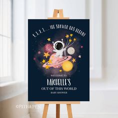 an easel with a sign on it that says welcome to maculies out of this world