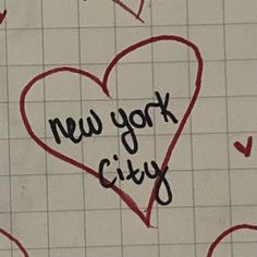 the words new york city written in black ink on a white tiled wall with red hearts