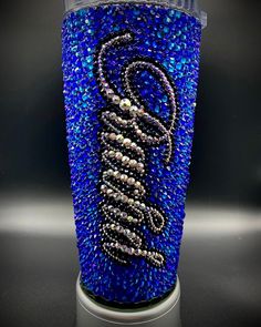 a blue glass with some beads on it