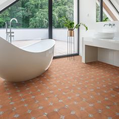 a bathroom with a large bathtub next to a sink and a window in it