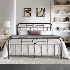 a bedroom with a metal bed frame and white walls