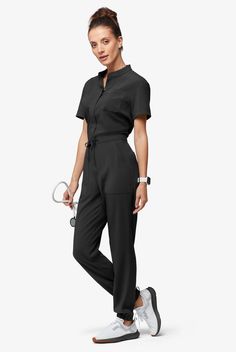 Now, this is modern. A jumpsuit! No easier way to get dressed – nothing to match and your top stays tucked in. Ours is so cute – a drawstring to add shape plus six functional pockets. The Easy Stretch Collection is designed for a modern look and easy fit. 4-way stretch performance fabric keeps you comfortable all shift long. • Modern fit ��• Open placket neckline • Concealed full-length front zipper • Drawstring waist • Total of 6 pockets • 2 roomy front patch pockets • 1 cellphone pocket • 2 back Scrub Style, Dickies Scrubs, Jumpsuit Outfits, Short Sleeve Jumpsuit, Mens Scrubs, Scrub Jackets, Easy Stretches, Tall Pants, Short Sleeve Jumpsuits