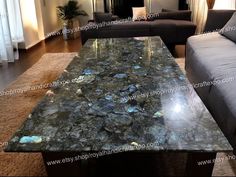 a living room filled with furniture and a table covered in rocks on top of it