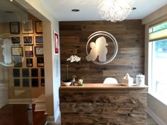 a reception area with wood paneled walls and chandelier