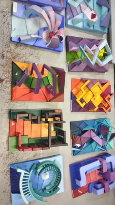 several pieces of art made out of colored paper