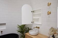 a black bath tub sitting next to a white sink