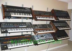 there are many electronic keyboards lined up on the wall