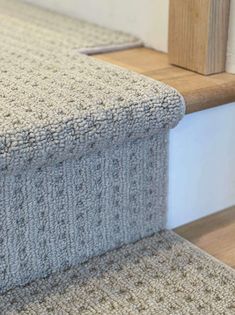 a close up view of a carpeted stair tread