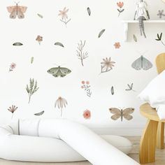 a white room with flowers and butterflies on the wall