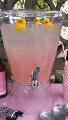 a pink drink with rubber ducks floating in it