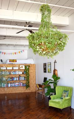 a living room filled with furniture and a green chair