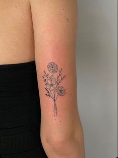 a woman's arm with a flower tattoo on the left side of her body