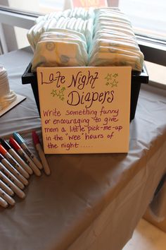 a sign that says late night diapers on top of a table with other items