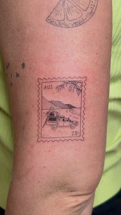 a woman with a tattoo on her arm has a stamp that says us and an image of a camper