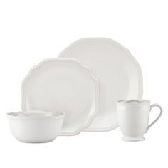 a white dinner set with two cups and saucers