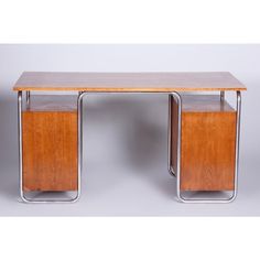 a wooden desk with two metal legs