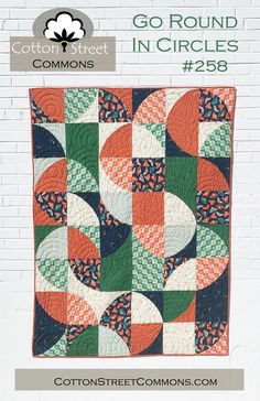 the cover of go round in circles quilt pattern is shown on a white brick wall