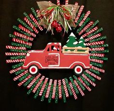 a christmas wreath with a red truck and candy canes