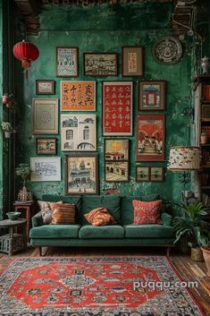 a living room with green walls and lots of pictures on the wall above the couch