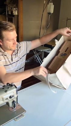 a man is working on something with a sewing machine