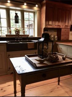 a kitchen with wooden floors and an old fashioned table in the middle of the room