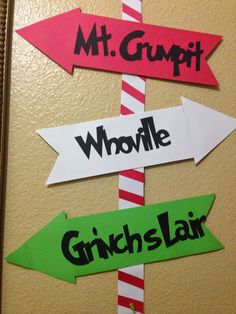 a bulletin board with directional signs and candy canes attached to the boards that read mt grupit, whoville, grin's - lar