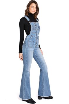 Stand out in these 70s-inspired overalls with a multi-pocket, button-down bib and suspender straps that cross at the back. High-rise silhouette with flare style bottoms finished with a perfect frayed edge. Crafted to blend style, comfort, and functionality seamlessly. Made from premium quality stretchy denim, these overalls offer the perfect balance of durability and flexibility, ensuring you stay comfortable throughout the day. CARE | Machine Wash Cold Inside Out CONTENTS | 67% Cotton, 29% Poly Denim Blue Jeans Overalls With Suspenders, Denim Jumpsuit With Suspenders, Medium Wash Denim Jumpsuit With Suspenders And Bib Front, Denim Bib Front Bottoms For Fall, Denim Overalls With Buttons, High Rise Overalls In Medium Wash With Button Closure, High Rise Medium Wash Overalls With Button Closure, Blue Jean Jumpsuit Outfits, Jean Jumpsuit Outfit