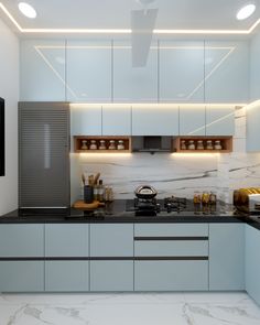 a modern kitchen with marble counter tops and white cupboards, along with black counters