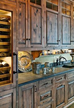 a large kitchen with wooden cabinets and glass doors on the front door is shown in this image