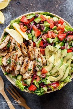 a salad with chicken, avocado and tomatoes