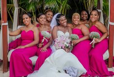 a group of women in pink dresses posing for a photo