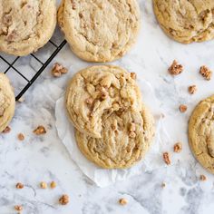 several cookies on a cooling rack with walnuts