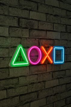 a neon sign that says xoxo on it's side next to a brick wall