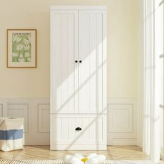 a white armoire sitting in the middle of a room