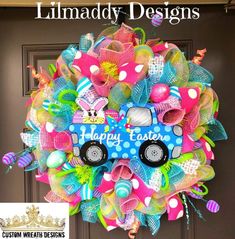 the front door is decorated with colorful deco mesh wreaths and an easter bunny truck