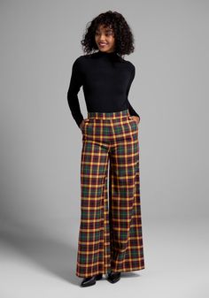 In an exclusive plaid print made up of rich and earthy tones of mustard, green, and burgundy, these fabulous flare pants from our ModCloth namesake label are a true retro-chic moment. Made from a stretchy woven fabric, these stylish plaid pants boast a high-rise waistline, button detailing at the front, front and back pockets, and a full-length flare leg. Create a vintage inspired look with a smart fitted turtleneck, or bring your look up to date with a cropped graphic tee, either way you’ll lov Holiday Party Pants, Plus Size Vintage Clothing, Designer Plus Size Clothing, Green And Burgundy, Mustard Green, Outfits 70s, Statement Outfit, 70s Outfits, Fitted Turtleneck