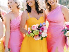 the bridesmaids are all wearing bright pink and yellow dresses, one is holding a bouquet