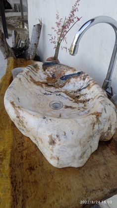 a sink that is sitting on top of a wooden table with a faucet