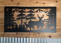 two deer are standing in the woods with pine trees behind them on a wood paneled wall