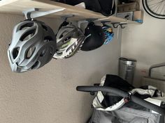 there is a bike helmet hanging on the wall next to a bag and bicycle gear