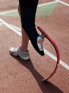 a person standing on top of a tennis court holding a racquet in their hand