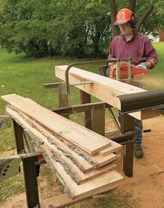 a man is working on some wood in the yard with a chainsaw and saw