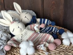 two knitted rabbits sitting next to each other in a basket