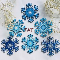 blue snowflakes with the word tat written on them