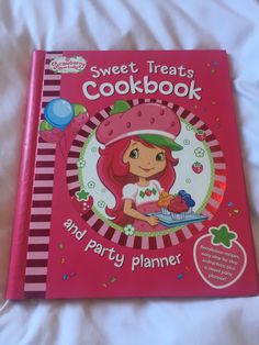 strawberry shortcakes cookbook and party planner for kids with pink cover on bed