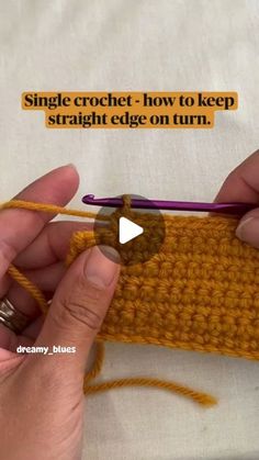 someone is crocheting the edge of a piece of fabric