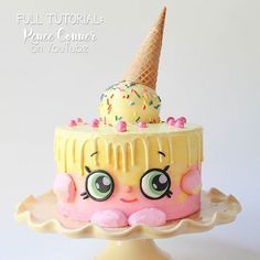 a close up of a cake with an ice cream cone on top