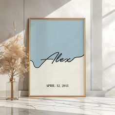 a poster with the name alex on it next to a vase with flowers in it