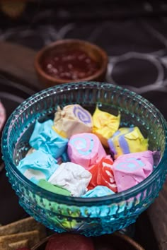 a glass bowl filled with different colored candy